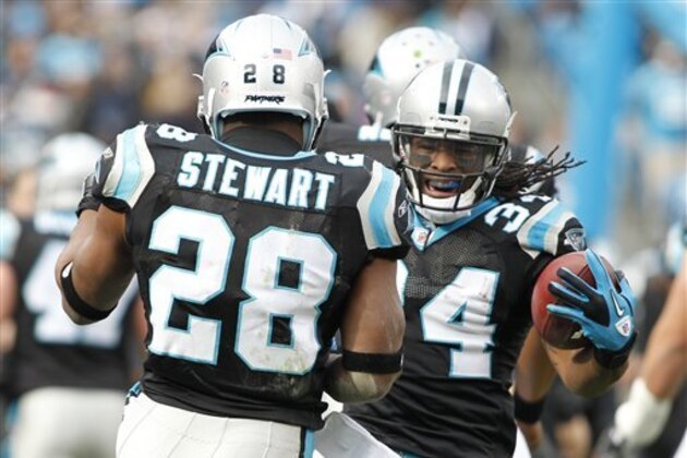 Carolina Panthers' DeAngelo Williams (34) reacts with teammate  Jonathan Stewart (28) after Williams' touchdown run against the Tampa Bay Buccaneers during the first quarter of an NFL football game in Charlotte, N.C., Saturday, Dec. 24, 2011. (AP Photo/Bob Leverone)