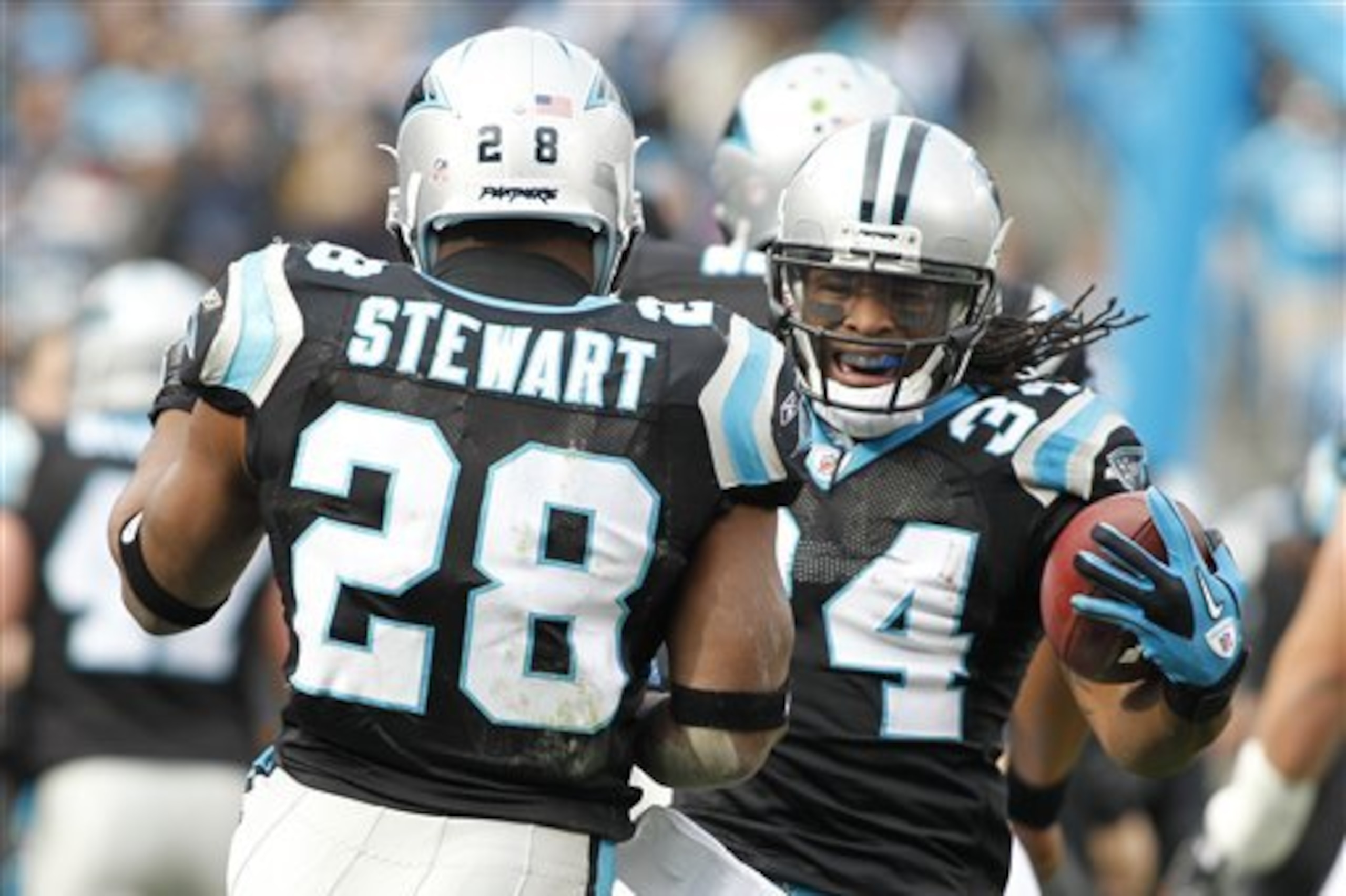 Carolina Panthers' DeAngelo Williams (34) reacts with teammate  Jonathan Stewart (28) after Williams' touchdown run against the Tampa Bay Buccaneers during the first quarter of an NFL football game in Charlotte, N.C., Saturday, Dec. 24, 2011. (AP Photo/Bob Leverone)