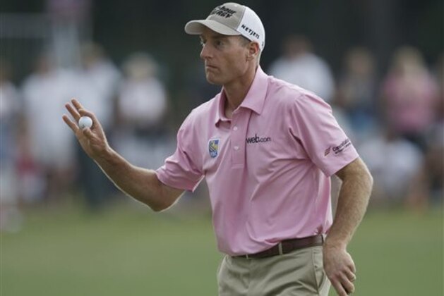 Jim Furyk shows his ball on the 17th green during the final round of The Players championship golf tournament at TPC Sawgrass, Sunday, May 11, 2014, in Ponte Vedra Beach, Fla. (AP Photo/Gerald Herbert)