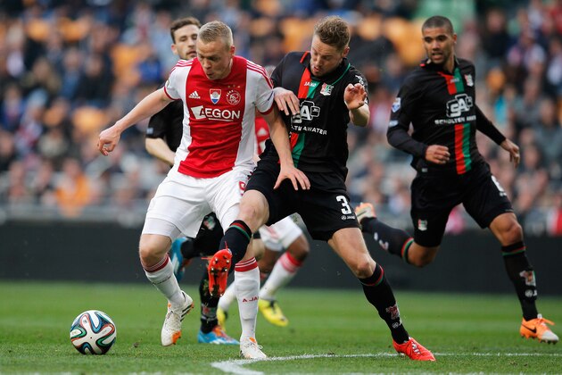 AMSTERDAM, NETHERLANDS - MAY 03:  Kolbeinn Sigthorsson of Ajax and Rens Van Eijden of NEC battle for the ball during the Eredivisie match between Ajax Amsterdam and NEC Nijmegen at Amsterdam Arena on May 3, 2014 in Amsterdam, Netherlands.  (Photo by Dean Mouhtaropoulos/Getty Images)