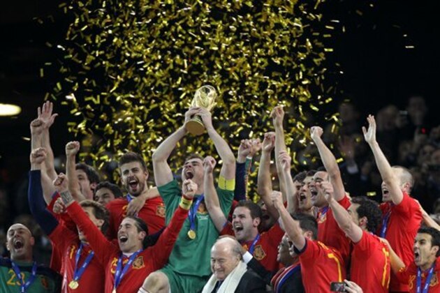 Spain team members celebrate with the World Cup trophy after the World Cup final soccer match between the Netherlands and Spain at Soccer City in Johannesburg, South Africa, Sunday, July 11, 2010.  (AP Photo/Frank Augstein)