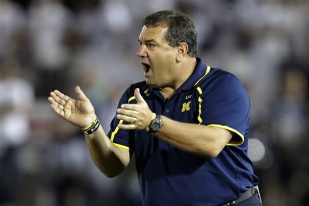 FILE - In this Oct. 12, 2013 file photo, Michigan head coach Brady Hoke walks the sidelines during the third quarter an NCAA college football game against Penn State in State College, Pa. It's been two years since the last time Ohio State played at Michigan. A lot has happened to both programs since. (AP Photo/Gene J. Puskar, File) FILE - In this Oct. 12, 2013 file photo, Michigan head coach Brady Hoke walks the sidelines during the third quarter an NCAA college football game against Penn State in State College, Pa. It's been two years since the last time Ohio State played at Michigan. A lot has happened to both programs since. (AP Photo/Gene J. Puskar, File)