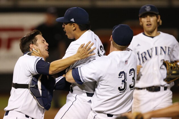 UC Irvine catcher Jerry McClanahan, left, pitcher Andrew Morales, center, first baseman Connor Spencer (33) and third baseman Taylor Sparks, right, celebrate following an NCAA college baseball tournament super regional game in Stillwater, Okla., Saturday, June 7, 2014. UC Irvine won 1-0 to move on to the College World Series in Omaha. (AP Photo/Sue Ogrocki)