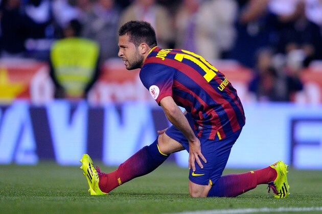 Barcelona's Jordi Alba grimaces while holding his leg during the final of the Copa del Rey between FC Barcelona and Real Madrid at the Mestalla stadium in Valencia, Spain, Wednesday, April 16, 2014. (AP Photo/Manu Fernandez)
