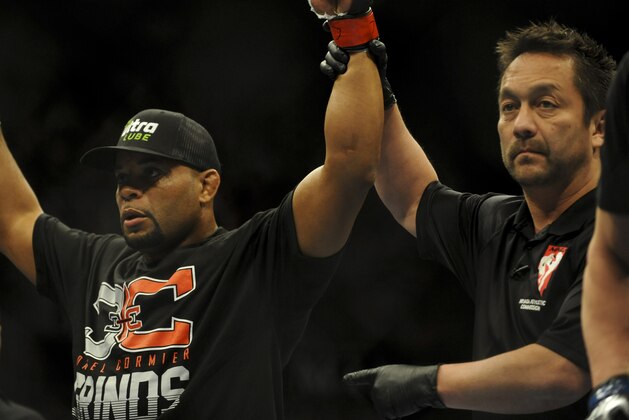 Feb 22, 2014; Las Vegas, NV, USA;  Daniel Cormier (red gloves) celebrates his victory of Pactrick Cummins (not pictured) after their UFC light heavyweight bout at Mandalay Bay. Cormier won by way of a TKO in the first round. Mandatory Credit: Stephen R. Sylvanie-USA TODAY Sports