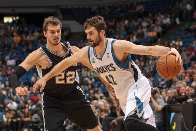 Apr 8, 2014; Minneapolis, MN, USA; Minnesota Timberwolves forward Kevin Love (42) dribbles against San Antonio Spurs center Tiago Splitter (22) at Target Center. Mandatory Credit: Brad Rempel-USA TODAY Sports