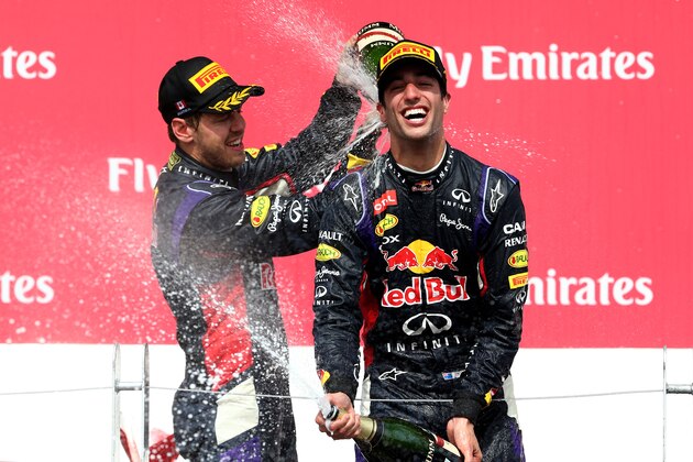 MONTREAL, QC - JUNE 08:  Racewinner Daniel Ricciardo of Australia and Infiniti Red Bull Racing is sprayed with champagne by teammate Sebastian Vettel of Germany and Infiniti Red Bull Racing following his victory during the Canadian Formula One Grand Prix at Circuit Gilles Villeneuve on June 8, 2014 in Montreal, Canada.  (Photo by Mark Thompson/Getty Images)