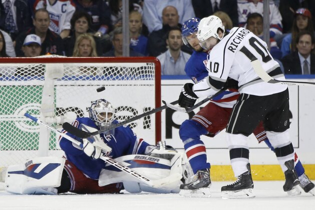 New York Rangers goalie Henrik Lundqvist (30) blocks a shot by Los Angeles Kings center Mike Richards (10) as Rangers defenseman Anton Stralman (6) helps defend in the second period during Game 3 of the NHL hockey Stanley Cup Final, Monday, June 9, 2014, in New York. (AP Photo/Kathy Willens)