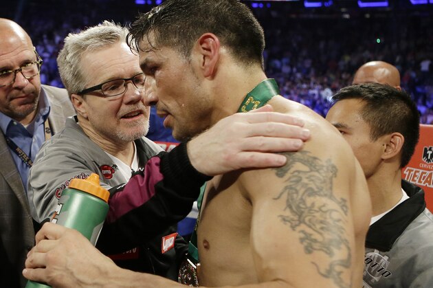 Trainer Freddie Roach talks with Sergio Martinez, of Argentina, after a WBC World Middleweight Title boxing match against Miguel Cotto, of Puerto Rico, Sunday, June 8, 2014, in New York.  Cotto won the fight. (AP Photo/Frank Franklin II)
