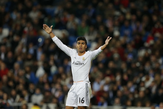 Real's Casemiro protests during a Copa del Rey soccer match between Real Madrid and third-division club Xativa Olimpic at the Bernabeu stadium in Madrid, Wednesday Dec. 2013. (AP Photo/Paul White)
