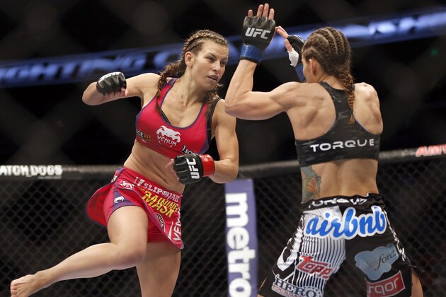 Miesha Tate, left, and Liz Carmouche fight in a mixed martial arts event on Saturday, April 19, 2014, at UFC Fight Night in Orlando Fla. Tate defeated Carmouche. (AP Photo/Reinhold Matay)