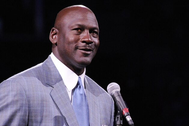 Dec 21, 2013; Charlotte, NC, USA; Charlotte Bobcats owner Michael Jordan unveils the new Charlotte Hornets logo at halftime during the game against the Utah Jazz at Time Warner Cable Arena. Mandatory Credit: Sam Sharpe-USA TODAY Sports