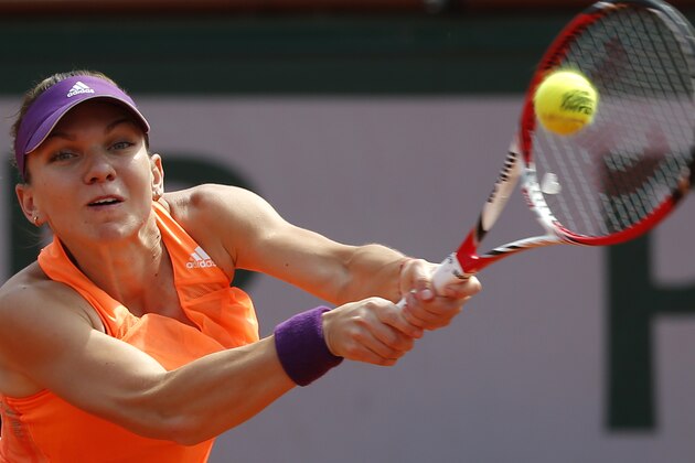 Romania's Simona Halep returns the ball to Russia's Maria Sharapova during their final match of  the French Open tennis tournament at the Roland Garros stadium, in Paris, France, Saturday, June 7, 2014. (AP Photo/Michel Euler)