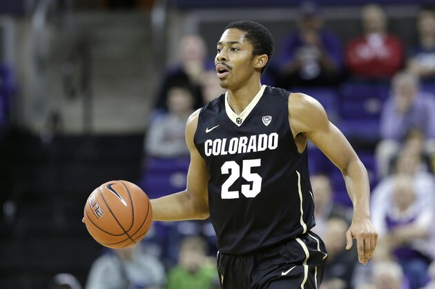 Spencer Dinwiddie dribbles up court against Washington in the first half of an NCAA men's basketball game Sunday, Jan. 12, 2014, in Seattle. (AP Photo/Elaine Thompson)