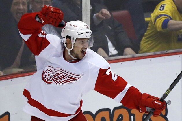 Detroit Red Wings' Tomas Tatar, left, of Slovakia, celebrates his third-period goal that tied the NHL hockey game against the Pittsburgh Penguins at 3-3, Thursday, March 20, 2014, in Detroit. The Red Wings defeated the Penguins 5-4 in overtime. (AP Photo/Duane Burleson)