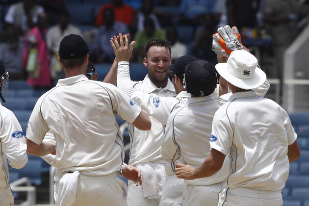 New Zealand's bowler Mark Craig, center facing camera, celebrates with teammates after taking the wicket of West Indies Kirk Edwards who was caught by New Zealand's Ross Taylor for a duck during the third day of their first cricket Test match in Kingston, Jamaica, Tuesday, June 10, 2014. (AP Photo/Arnulfo Franco)