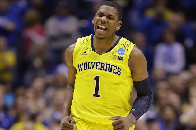 Michigan's Glenn Robinson III reacts after making a shot during the first half of an NCAA Midwest Regional final college basketball tournament game against Kentucky Sunday, March 30, 2014, in Indianapolis. (AP Photo/Michael Conroy)