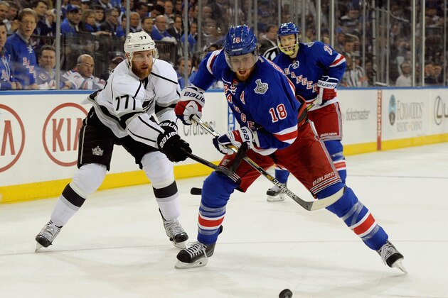 NEW YORK, NY - JUNE 09:  Jeff Carter #77 of the Los Angeles Kings tries to stop Marc Staal #18 of the New York Rangers in the first period of Game Three of the 2014 Stanley Cup Final at Madison Square Garden on June 9, 2014 in New York City.  (Photo by Andrew D. Bernstein/NHLI via Getty Images)