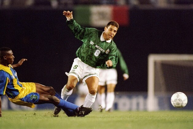 11 Jan 1996:  Alberto Garcia Aspe of Mexico trips over Cornelius Huggins of St. Vincent during a game.  Mexico won the game 5-0. Mandatory Credit: Stephen Dunn  /Allsport