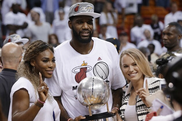 Tennis players Serena Williams, left and Caroline Wozniacki pose with Miami Heat's Greg Oden and the NBA basketball Eastern Conference championship trophy, Friday, May 30, 2014, in Miami. The Miami Heat defeated the Indiana Pacers 117-92 to advance to the NBA finals. (AP Photo/Lynne Sladky)