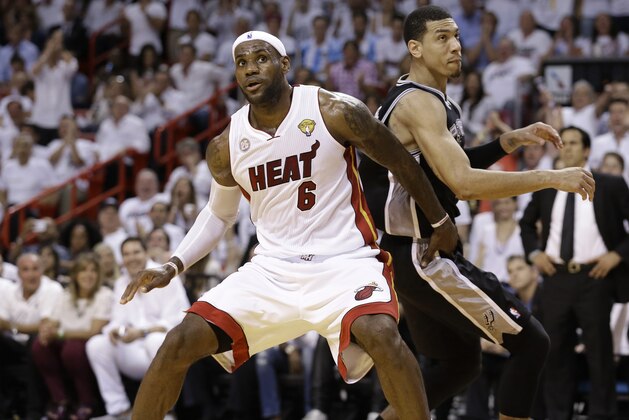 The Miami Heat's LeBron James (6) and San Antonio Spurs' Danny Green (4) work during the first half in Game 7 of the NBA basketball championships, Thursday, June 20, 2013, in Miami. (AP Photo/Lynne Sladky)