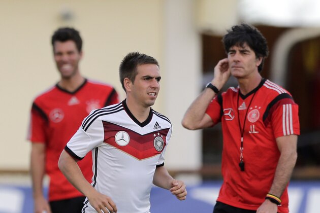 Germany's national soccer player Philipp Lahm warms up besides head coach Joachim Loew during a training session in Santo Andre near Porto Seguro, Brazil, Tuesday, June 10, 2014. Germany will play in group G of the 2014 soccer World Cup. (AP Photo/Matthias Schrader)