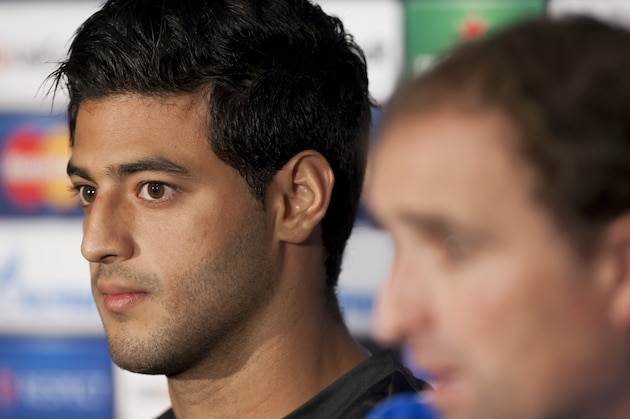 Real Sociedad's Carlos Vela, left, sits alongside coach Jagoba Arrasate during a press conference at Manchester United's Old Trafford Stadium, Manchester, England, Tuesday, Oct. 22, 2013. Real Sociedad will play  Manchester United in a Champion's League Group A soccer match on Wednesday. (AP Photo/Jon Super)