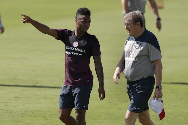 England's Raheem Sterling speaks with his manager Roy Hodgson during a squad training session for the 2014 soccer World Cup at the Urca military base in Rio de Janeiro, Brazil, Monday, June 9, 2014.  (AP Photo/Matt Dunham)