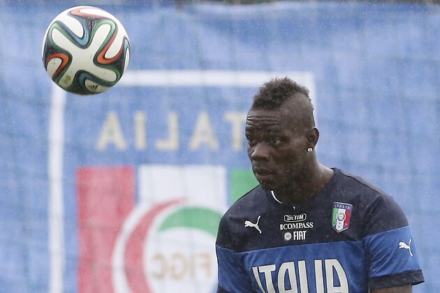 Italy's Mario Balotelli eyes the ball during a training session in the rain, in Mangaratiba, Brazil, Tuesday, June 10, 2014. Italy will play in group D of the Brazil 2014 soccer World Cup. (AP Photo/Antonio Calanni)