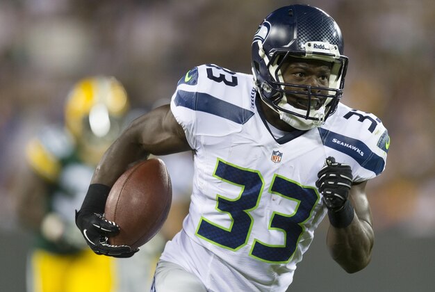 Aug 23, 2013; Green Bay, WI, USA; Seattle Seahawks running back Christine Michael (33) rushes for a touchdown during the third quarter against the Green Bay Packers at Lambeau Field.  Seattle won 17-10.  Mandatory Credit: Jeff Hanisch-USA TODAY Sports