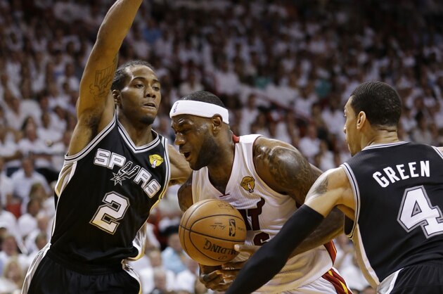 San Antonio Spurs forward Kawhi Leonard (2) and guard Danny Green (4) defend Miami Heat forward LeBron James (6), during the first half in Game 3 of the NBA basketball finals, Tuesday, June 10, 2014, in Miami. (AP Photo/Wilfredo Lee)
