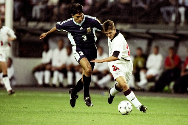 30 Jun 1998:  Michael Owen of England shrugs off Jose Chamot of Argentina on his way to goal during the World Cup second round match at the Stade Geoffroy Guichard in St Etienne, France. England lost 4-3 on penalties after a 2-2 draw. \ Mandatory Credit:Ross Kinnaird /Allsport