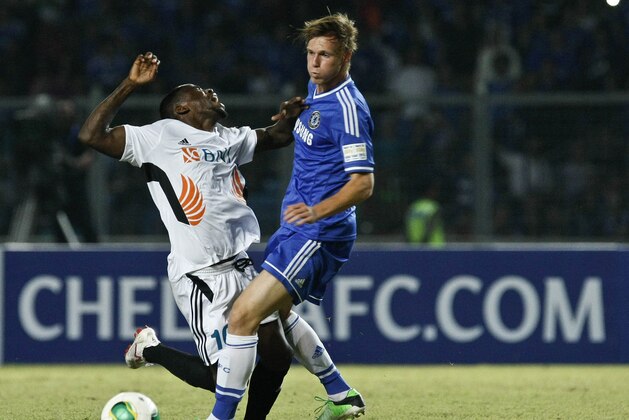 JAKARTA, INDONESIA - JULY 25:  Tomas Kalas (R) of Chelsea bettles for the ball with Greg Nwokolo (L) of Indonesia All-Stars during the match between Chelsea and Indonesia All-Stars at Gelora Bung Karno Stadium on July 25, 2013 in Jakarta, Indonesia.  (Photo by Ulet Ifansasti/Getty Images)