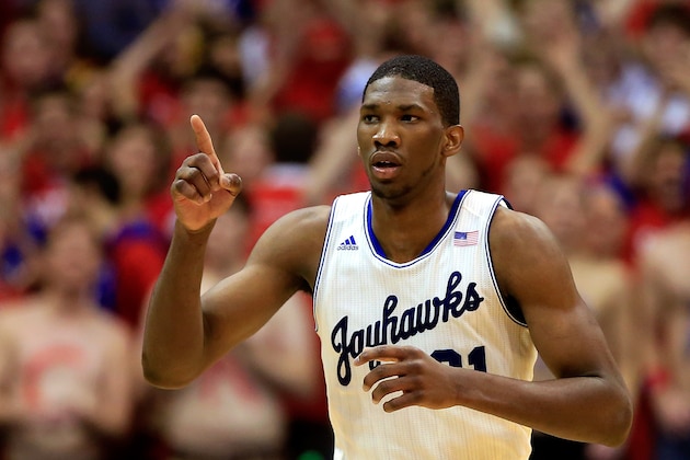 LAWRENCE, KS - JANUARY 18:  Joel Embiid #21 of the Kansas Jayhawks reacts after scoring during the game against the Oklahoma State Cowboys at Allen Fieldhouse on January 18, 2014 in Lawrence, Kansas.  (Photo by Jamie Squire/Getty Images)