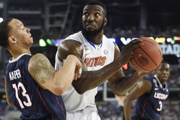 Apr 5, 2014; Arlington, TX, USA;Florida Gators center Patric Young (4) is defended by Connecticut Huskies guard Shabazz Napier (13) in the first half during the semifinals of the Final Four in the 2014 NCAA Mens Division I Championship tournament at AT&T Stadium. Mandatory Credit: Bob Donnan-USA TODAY Sports