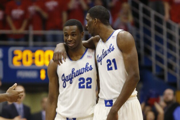 Kansas guard Andrew Wiggins (22) and center Joel Embiid (21) during the first half of an NCAA college basketball game against Oklahoma State at Allen Fieldhouse in Lawrence, Kan., Saturday, Jan. 18, 2014. (AP Photo/Orlin Wagner)