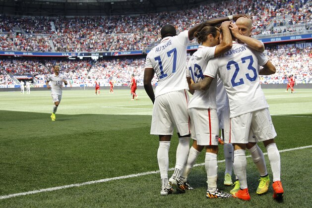 United States' Fabian Johnson (23) is congratulated by teammates after scoring a goal against Turkey in the first half of an international friendly soccer match on Sunday, June 1, 2014, in Harrison, N.J. (AP Photo/Julio Cortez)