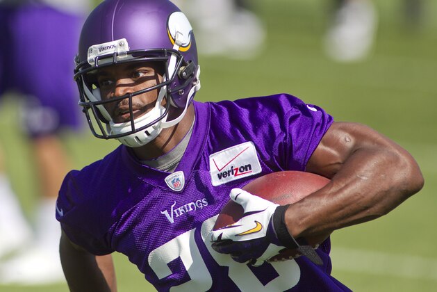 Minnesota Vikings running back Adrian Peterson (28) runs after making a catch in a drill at an NFL organized team activity at the Vikings football practice facility in Eden Prairie, Minn., Thursday, May  29, 2014.(AP Photo/Andy Clayton-King)