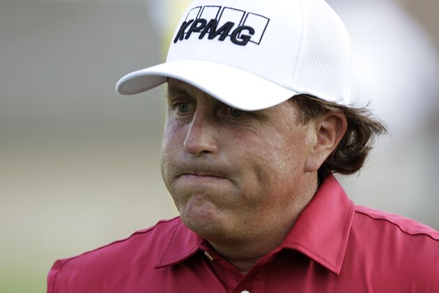 Phil Mickelson reacts after making double bogey on the 17th hole during the first round of the Memorial golf tournament Thursday, May 29, 2014, in Dublin, Ohio. (AP Photo/Jay LaPrete)
