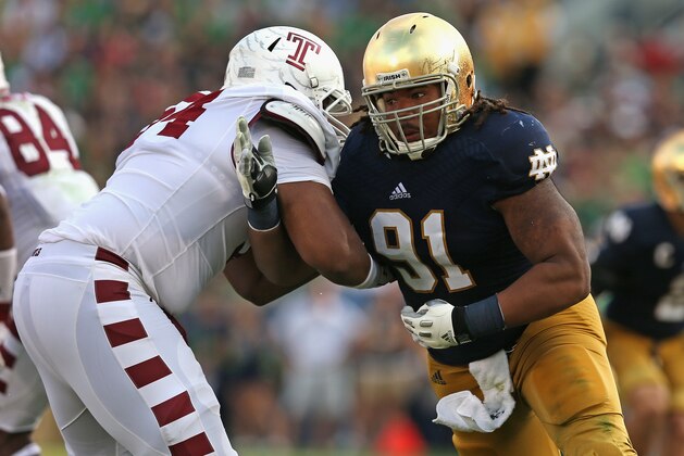 SOUTH BEND, IN - AUGUST 31:  Sheldon Day #91 of the Notre Dame Fighting Irish rushes against Zach Hooks #54 of the Temple Owls at Notre Dame Stadium on August 31, 2013 in South Bend, Indiana. Notre Dame defeated Temple 28-6.  (Photo by Jonathan Daniel/Getty Images)