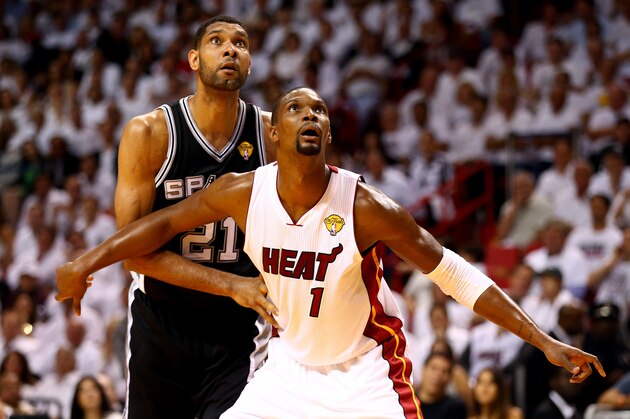 MIAMI, FL - JUNE 10: Chris Bosh #1 of the Miami Heat boxes out Tim Duncan #21 of the San Antonio Spurs during Game Three of the 2014 NBA Finals at American Airlines Arena on June 10, 2014 in Miami, Florida. NOTE TO USER: User expressly acknowledges and agrees that, by downloading and or using this photograph, User is consenting to the terms and conditions of the Getty Images License Agreement.  (Photo by Andy Lyons/Getty Images)