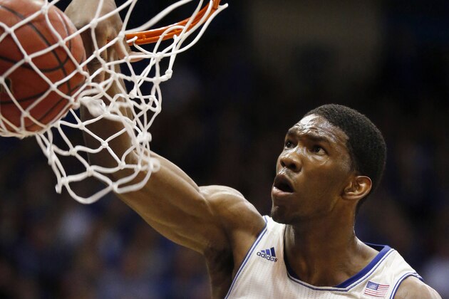 Kansas center Joel Embiid dunks during the first half of an NCAA college basketball game against Texas in Lawrence, Kan., Saturday, Feb. 22, 2014. (AP Photo/Orlin Wagner)