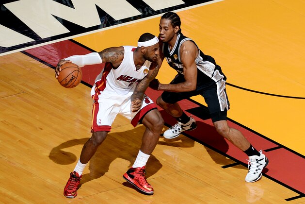 MIAMI, FL - JUNE 10: LeBron James #6 of the Miami Heat handles the ball against Kawhi Leonard #2 of the San Antonio Spurs in Game Three of the 2014 NBA Finals at American Airlines Arena on June 10, 2014 in Miami, Florida. NOTE TO USER: User expressly acknowledges and agrees that, by downloading and/or using this photograph, user is consenting to the terms and conditions of the Getty Images License Agreement.  Mandatory Copyright Notice: Copyright 2014 NBAE (Photo by Garrett Ellwood/NBAE via Getty Images)