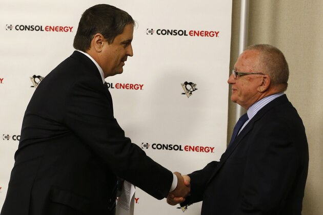 Jim Rutherford, right, shakes hands with Penguins President David Morehouse before he is introduced as the new general manager for the Pittsburgh Penguins NHL hockey team  at a news conference on Friday, June 6, 2014, in Pittsburgh. (AP Photo/Keith Srakocic)