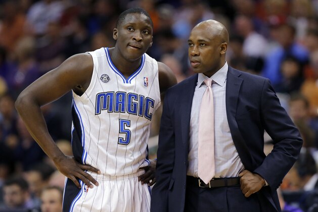 Orlando Magic guard Victor Oladipo (5) talks with coach Jacque Vaughn during the first half of an NBA basketball game against the Phoenix Suns, Wednesday, March 19, 2014, in Phoenix. (AP Photo/Matt York)
