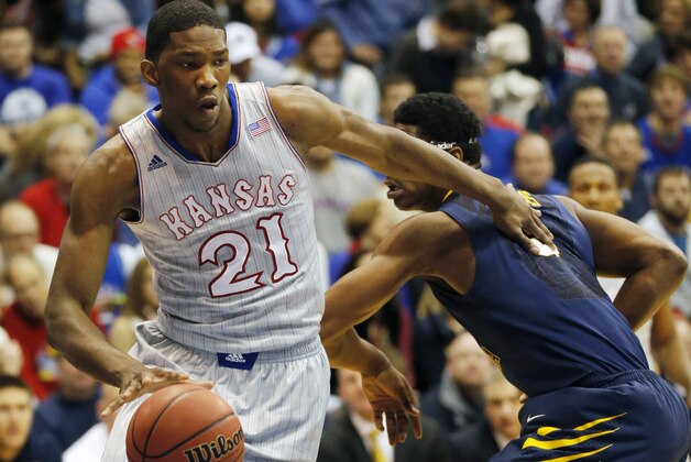 Kansas center Joel Embiid (21) pushes off West Virginia forward Devin Williams, right, during the first half of an NCAA college basketball game in Lawrence, Kan., Saturday, Feb. 8, 2014. Embiid scored 11 points in the game. Kansas defeated West Virginia 83-69. (AP Photo/Orlin Wagner) Kansas center Joel Embiid (21) pushes off West Virginia forward Devin Williams, right, during the first half of an NCAA college basketball game in Lawrence, Kan., Saturday, Feb. 8, 2014. Embiid scored 11 points in the game. Kansas defeated West Virginia 83-69. (AP Photo/Orlin Wagner)