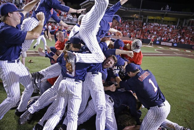 Mississippi celebrates their victory over Louisiana Lafayette during an NCAA college baseball tournament super regional game in Lafayette, La.,Monday, June 9, 2014. Mississippi won 10-4 to advance to the College World Series. (AP Photo/Gerald Herbert)