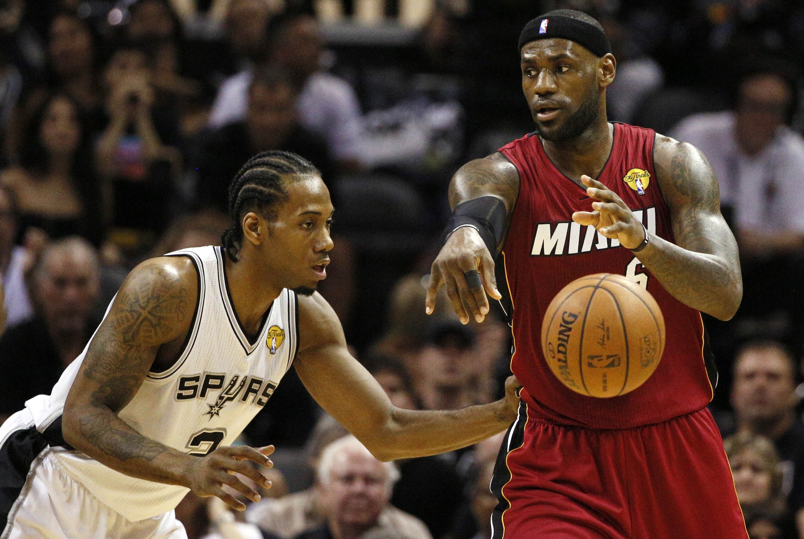 Jun 5, 2014; San Antonio, TX, USA; Miami Heat forward LeBron James (6) passes the ball against San Antonio Spurs forward Kawhi Leonard (2) during the first quarter in game one of the 2014 NBA Finals at AT&T Center. Mandatory Credit: Soobum Im-USA TODAY Sports
