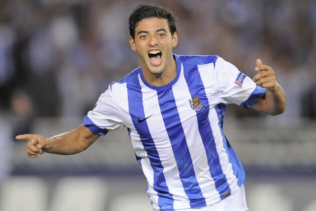 Real Sociedad's Carlos Vela of Mexico, left, celebrates after scoring his second goal against Olympique Lionnais during their Europa Champions League second leg, play-off soccer match, at Anoeta stadium in San Sebastian, northern Spain on Wednesday, Aug. 28, 2013. (AP Photo/Alvaro Barrientos) Real Sociedad's Carlos Vela of Mexico, left, celebrates after scoring his second goal against Olympique Lionnais during their Europa Champions League second leg, play-off soccer match, at Anoeta stadium in San Sebastian, northern Spain on Wednesday, Aug. 28, 2013. (AP Photo/Alvaro Barrientos)