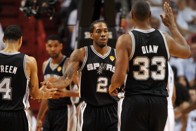 Jun 10, 2014; Miami, FL, USA; San Antonio Spurs forward Kawhi Leonard (2) high fives forward Boris Diaw (33) and guard Danny Green (4) during the first half of game three of the 2014 NBA Finals against the Miami Heat at American Airlines Arena. Mandatory Credit: Steve Mitchell-USA TODAY Sports